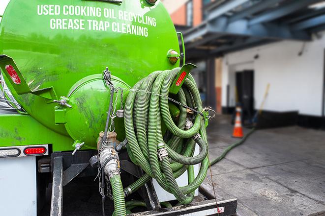 a professional service truck pumping a grease trap in Berlin